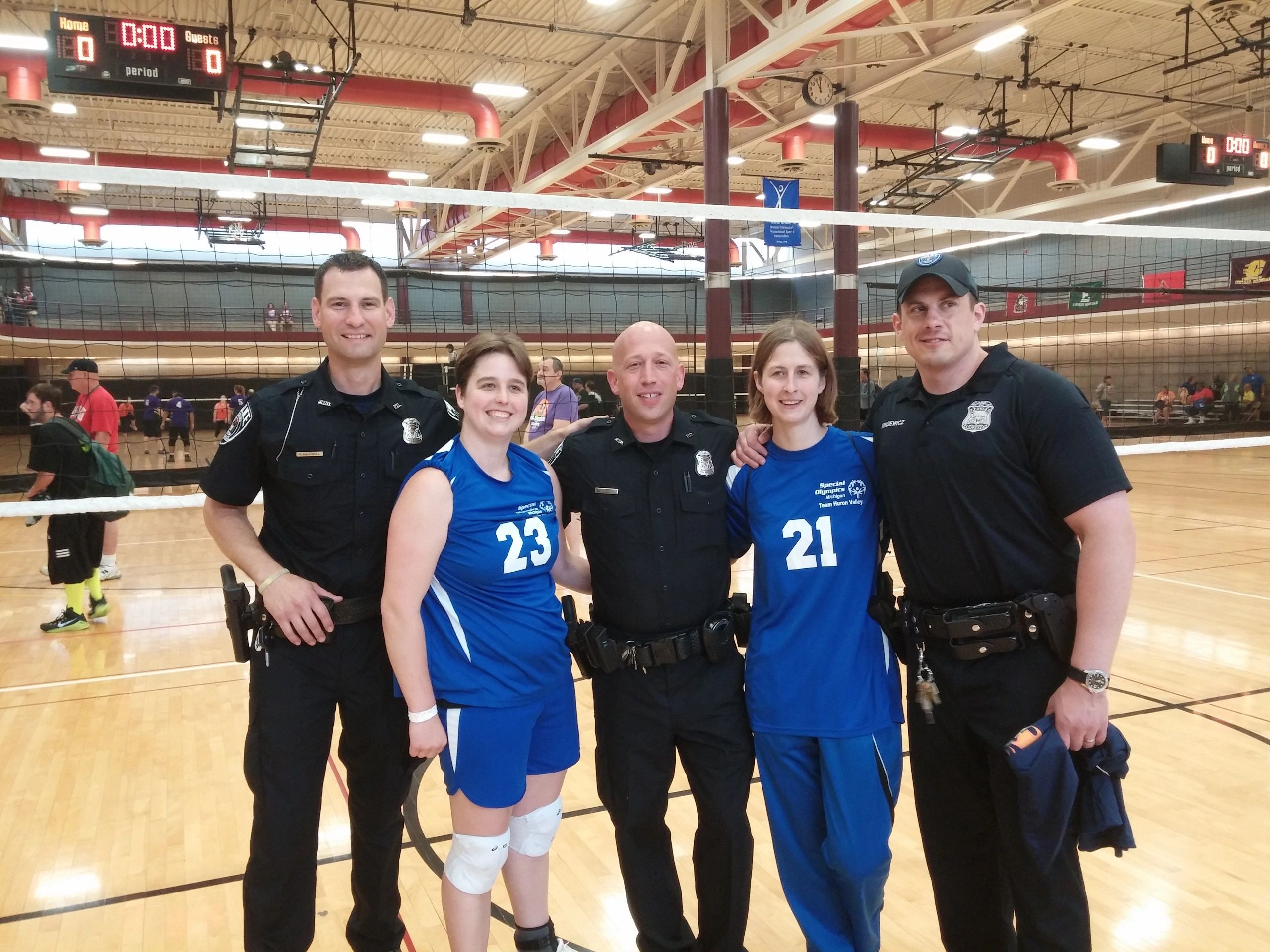 Volleyball team with law enforcement on court